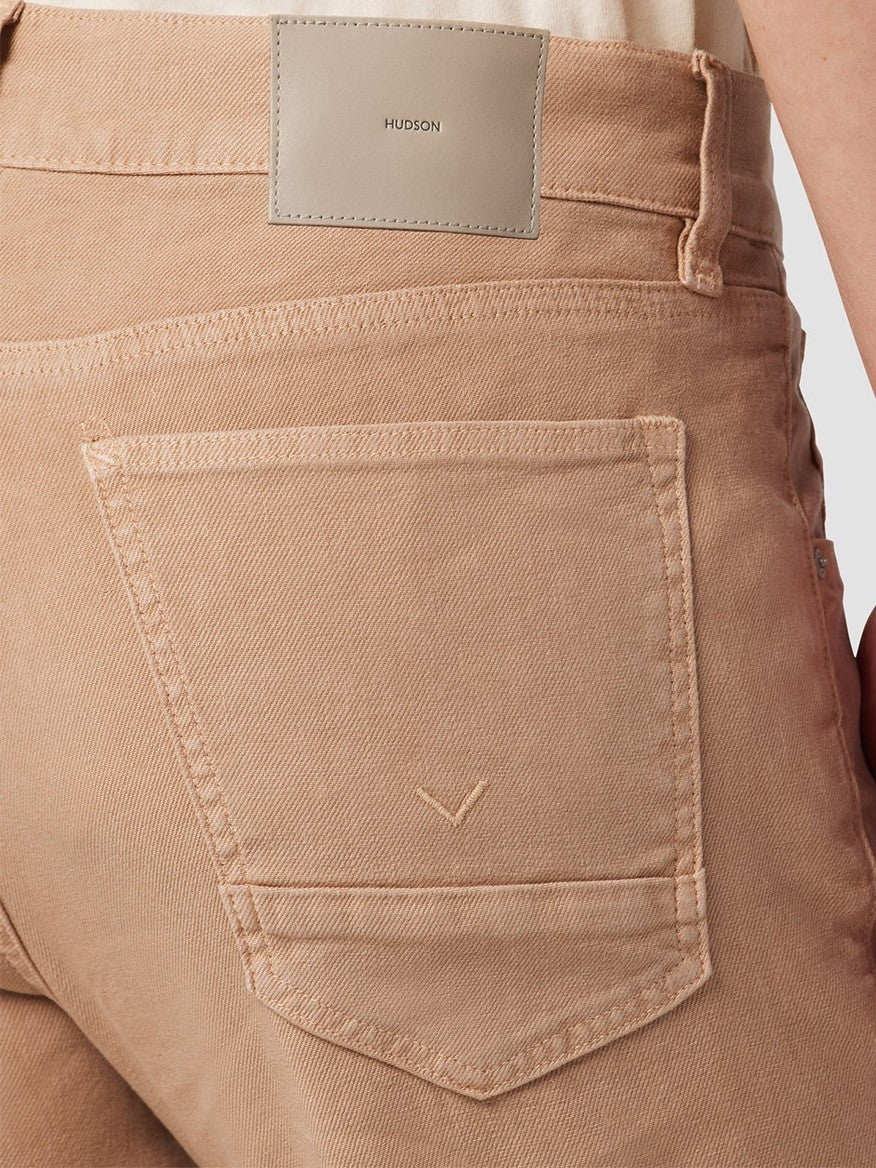Close-up of a Hudson Blake Slim Straight Twill Pant in Latte's back pocket with decorative stitching and a branded label.