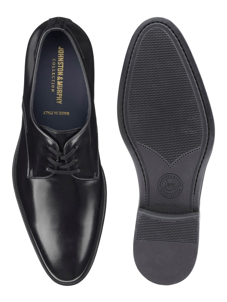 A pair of J & M Collection Flynch Plain Toe in Black Italian Calfskin shoes on a white background from the Johnston & Murphy Collection in Italy.
