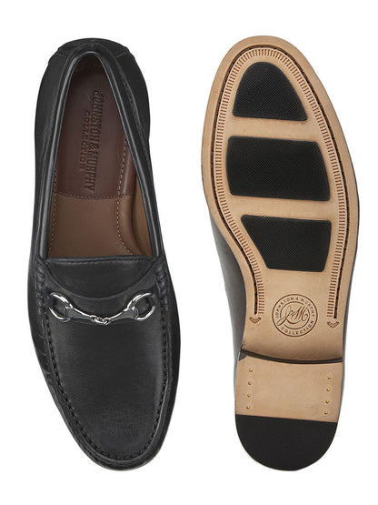 A pair of J & M Collection Baldwin Bit in Black Sheepskin loafers with a leather sole and sheepskin leather.