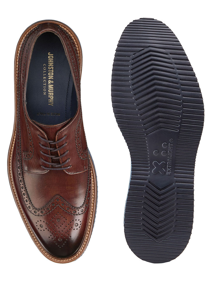 A top view of a J & M Collection Jameson Wingtip in Brown Italian Calfskin brogue shoe next to its sole, crafted by master artisans.