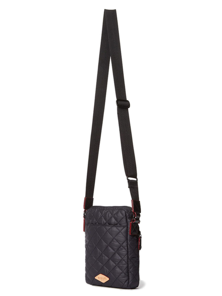 The MZ Wallace Metro Crossbody in Black Oxford is a quilted bag with an adjustable strap and a small Italian leather trim patch on the front.