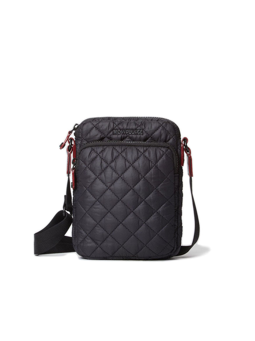 Introducing the MZ Wallace Metro Crossbody in Black Oxford: a sleek quilted bag with a rectangular shape, featuring a convenient front pocket and an adjustable shoulder strap. Meticulously crafted with Italian leather trim, it seamlessly combines style and functionality for any occasion.