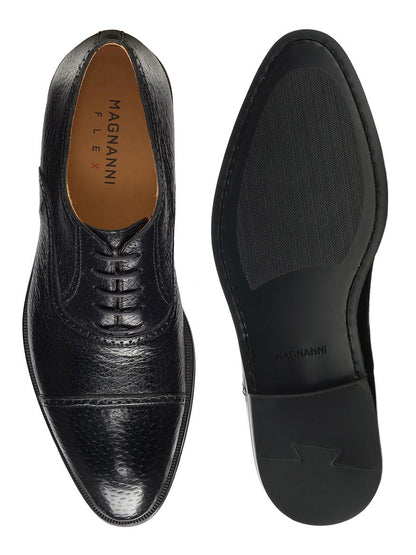 A pair of black Magnanni Ica cap toe Oxford dress shoes from their exotic collection viewed from above, showcasing the design and sole.