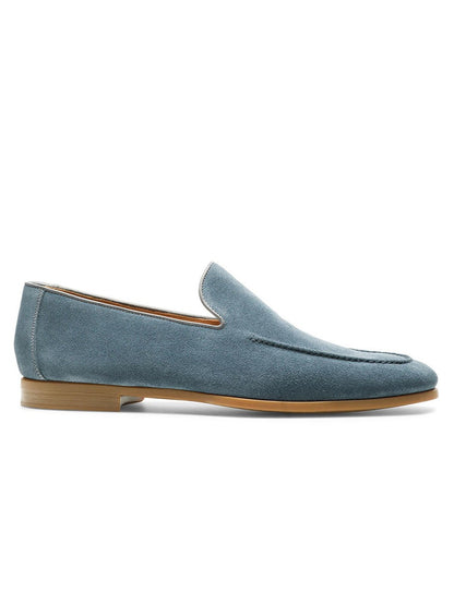 A single Magnanni Lecera loafer in indigo suede with a low tan sole is shown in profile on a white background.