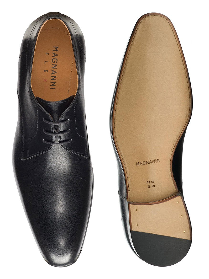 A pair of black plain toe derby shoes, Magnanni Maddin in Black, with a leather sole, showcased on a white background.