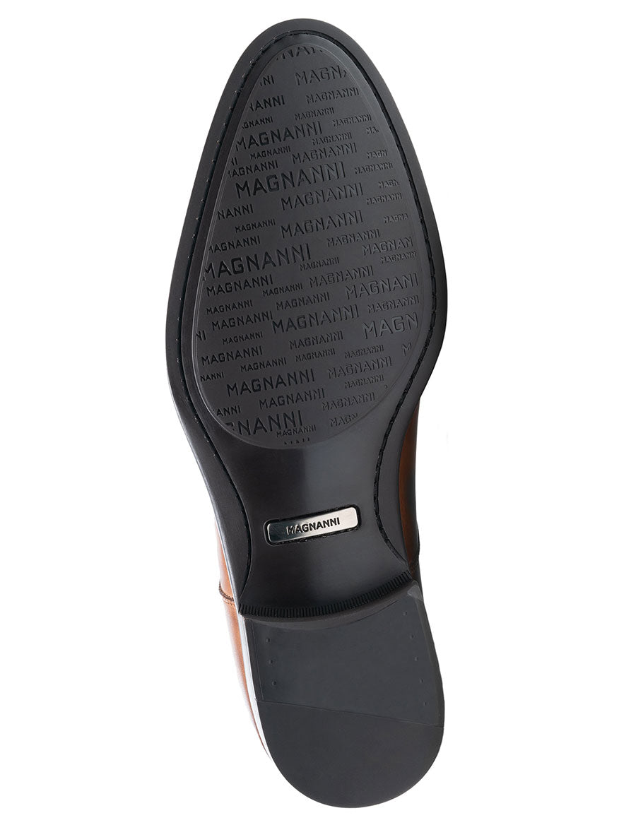 The Magnanni Alva in Tabaco, crafted with high-quality calfskin leather and featuring the iconic words on its back.