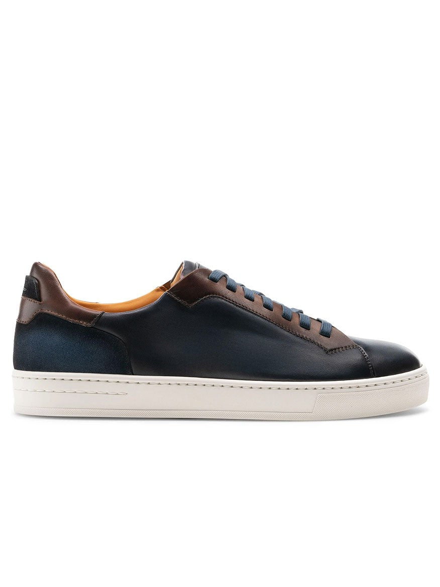 The Magnanni Amadeo in Navy & Brown is a luxury men's leather sneaker featuring a contemporary cupsole design in blue, with a stylish brown sole.