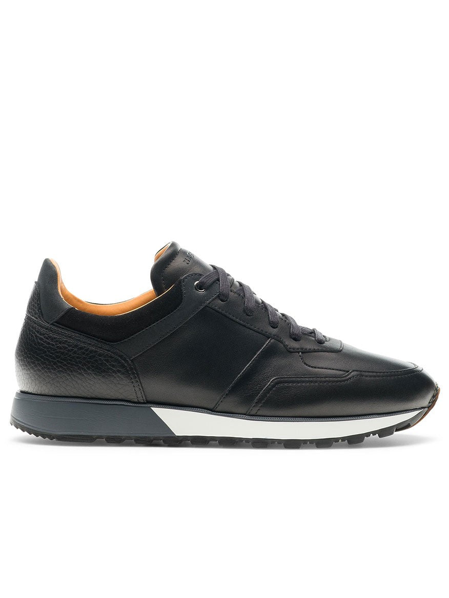 The Magnanni Arco in Black is a retro-inspired, low-top sport sneaker made from black leather, featuring a white sole and hand-stitched leather toe. Its black laces contrast the plain white backdrop while ensuring lightweight and flexible all-day comfort.