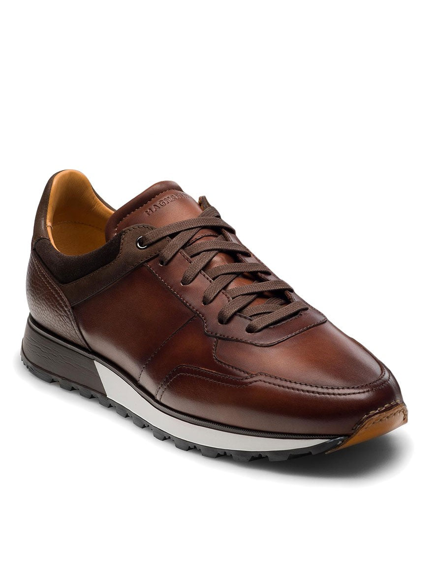 A retro-inspired men's brown leather sneaker, the Magnanni Arco in Midbrown, with a sport sneaker design.