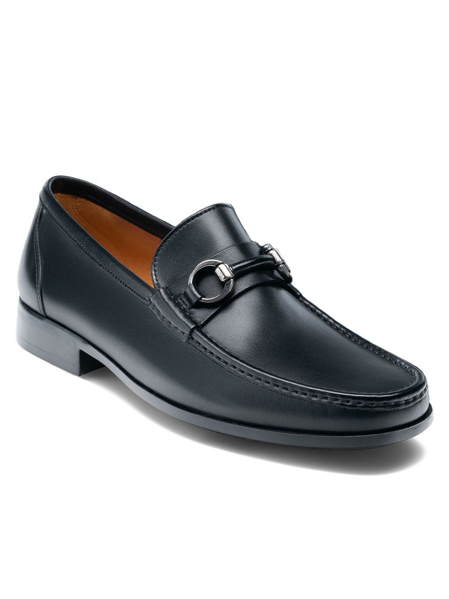 The Magnanni Blas II in Black is a black leather bit loafer with a metal bit detail on the upper, featuring a low heel, moccasin-style stitching, and a cushioned rubber sole. It is handmade in Spain.