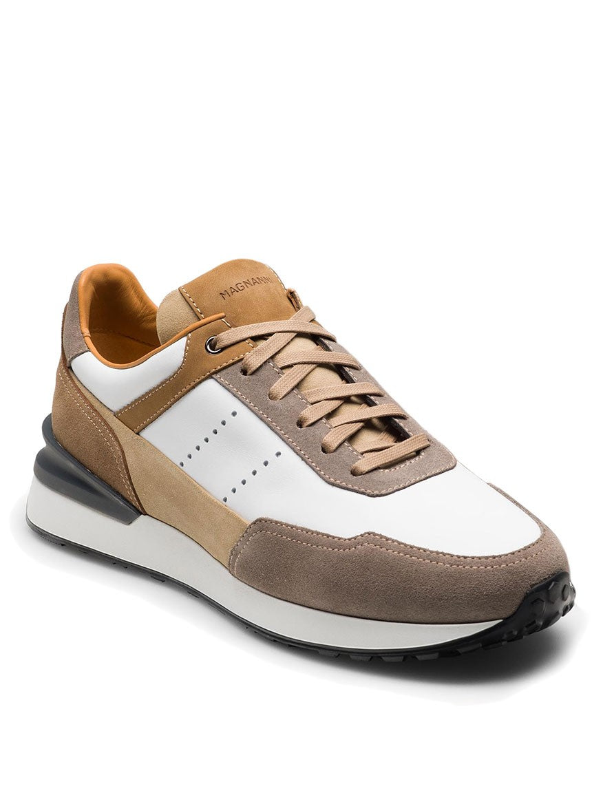 The Magnanni Bravo in White/Beige is a stylish sneaker with white leather, tan and beige suede panels, matching laces, and a black rubber sport sole for textured grip.