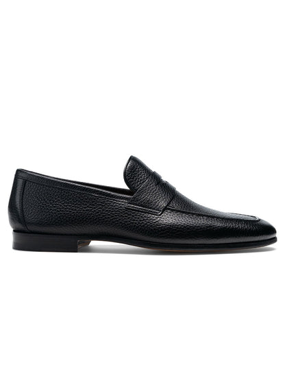 The Magnanni Diezma II in Black is a black loafer with a rubber sole, perfect for those seeking a timeless and comfortable shoe.