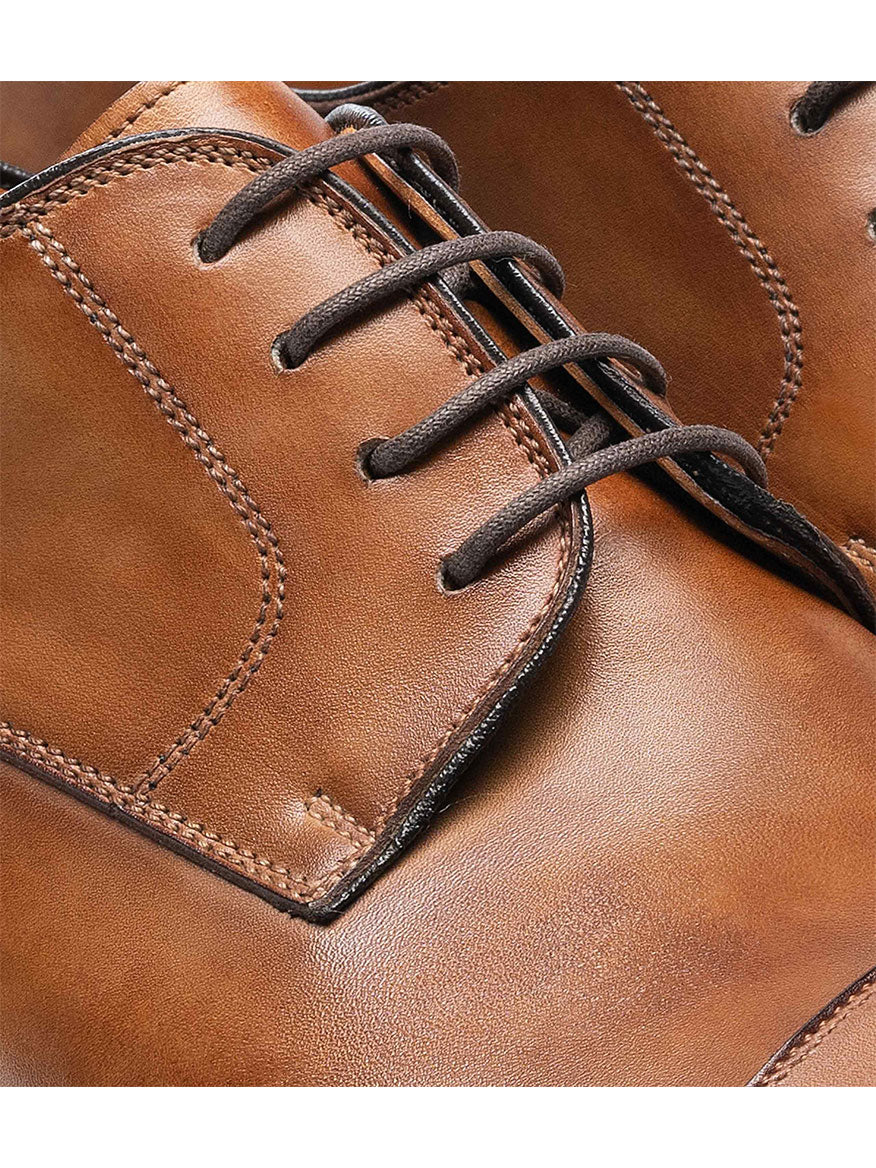 Close-up of a Magnanni Harlan in Tabaco with black laces.