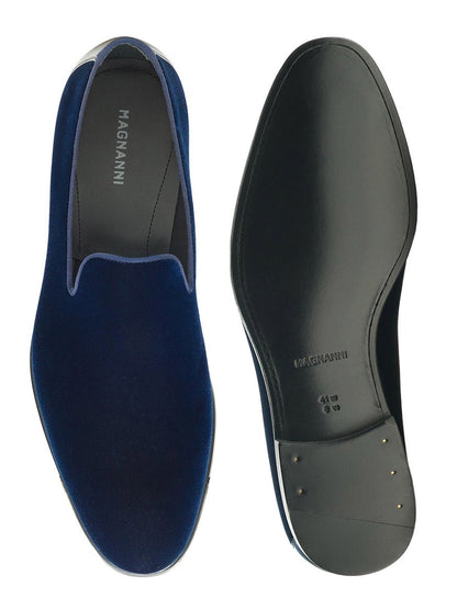 A pair of blue Magnanni Jareth in Navy Velvet slip-on shoes with black soles.