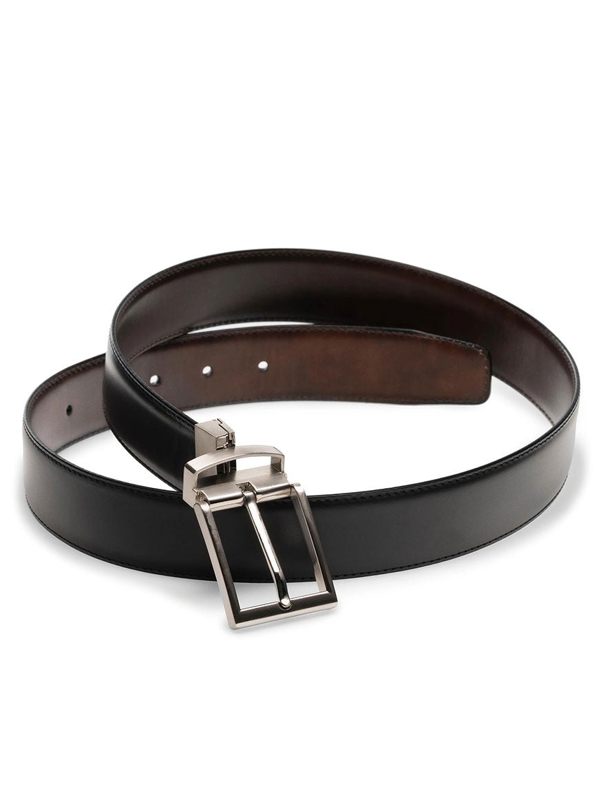 The Magnanni Lados Belt in Black/Brown Reversible, made in Spain, is a black calfskin leather belt with a silver buckle.