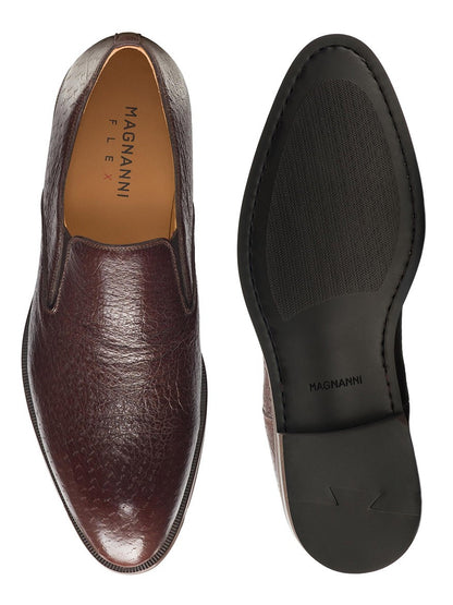 Top view of a Magnanni Lima in Brown peccary leather dress shoe next to its black sole, displayed against a white background.