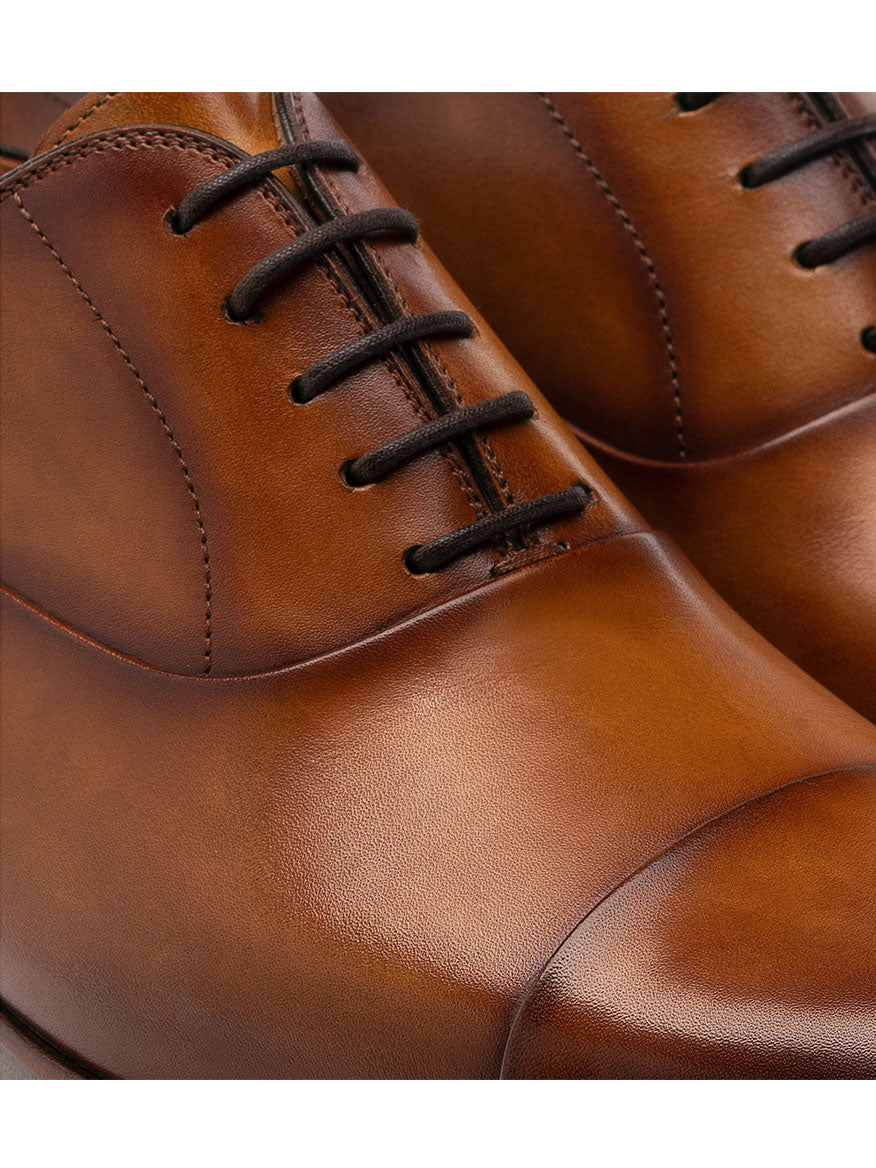 A pair of brown Magnanni Segovia in Curri derby shoes with Bologna construction on a white background.