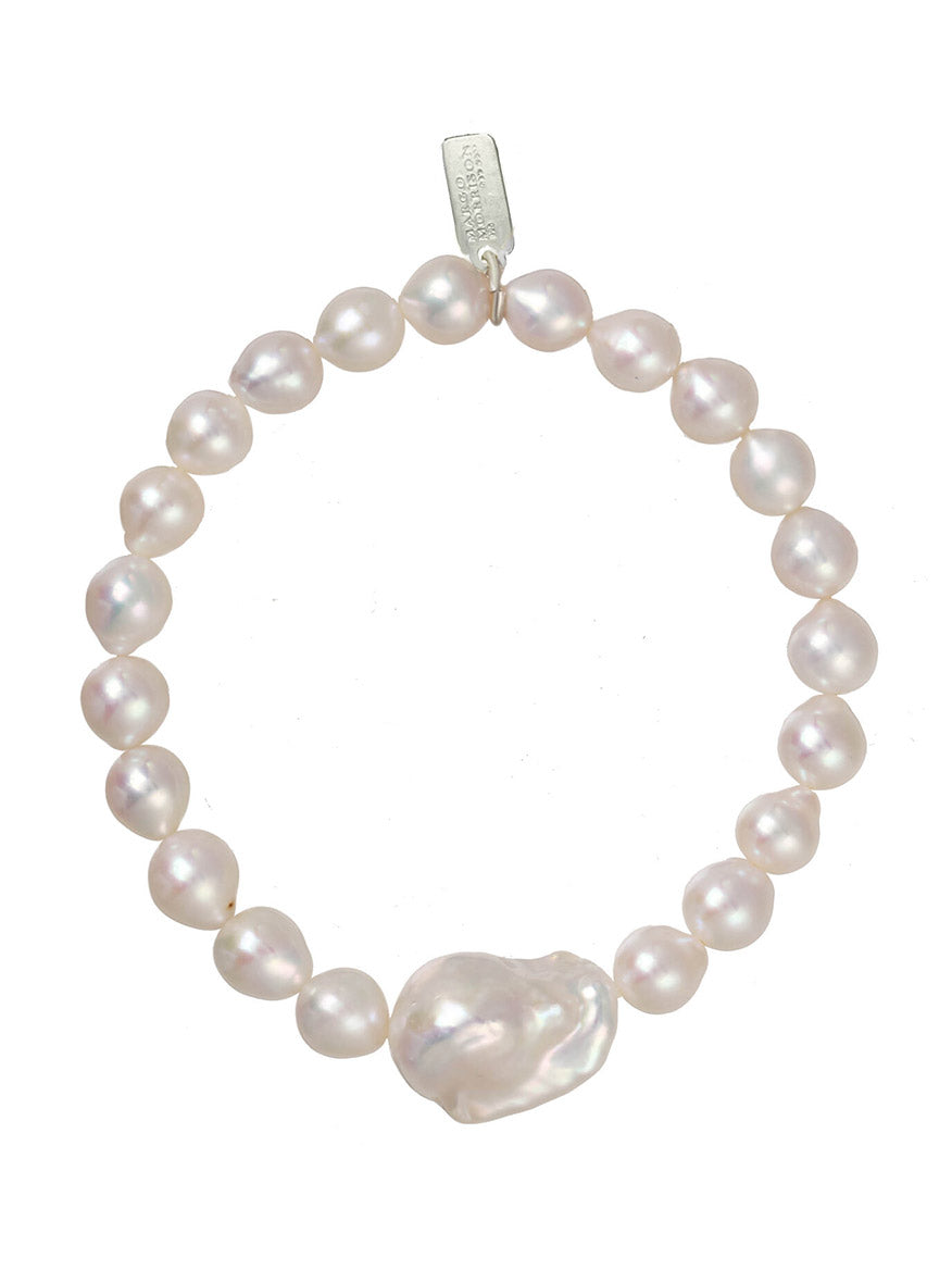 Margo Morrison Extra Small Baroque Pearl Stretch Bracelet with a heart-shaped charm on a white background.