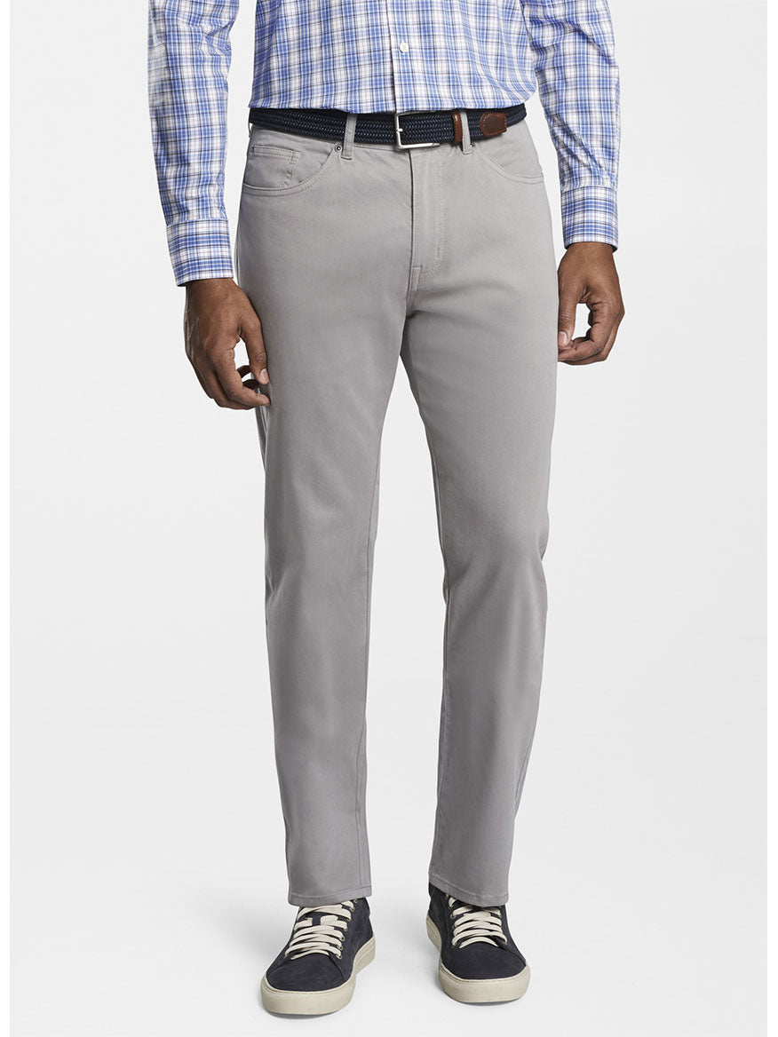 Man wearing Peter Millar Ultimate Sateen Five-Pocket Pant in Gale Grey, a checkered shirt, and casual shoes.