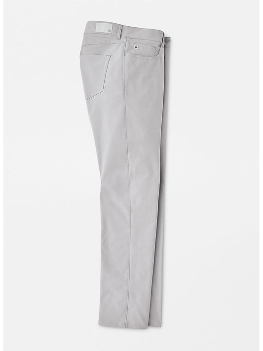 The Peter Millar Performance Five-Pocket Pant in Gale Grey with technical features on a white background.