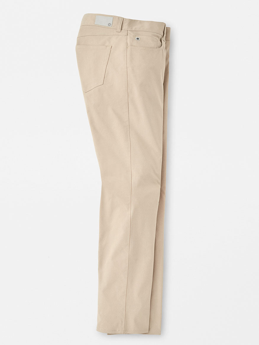 A pair of Peter Millar Performance Five-Pocket Pants in Khaki laid flat on a white background, showcasing front design and pockets.