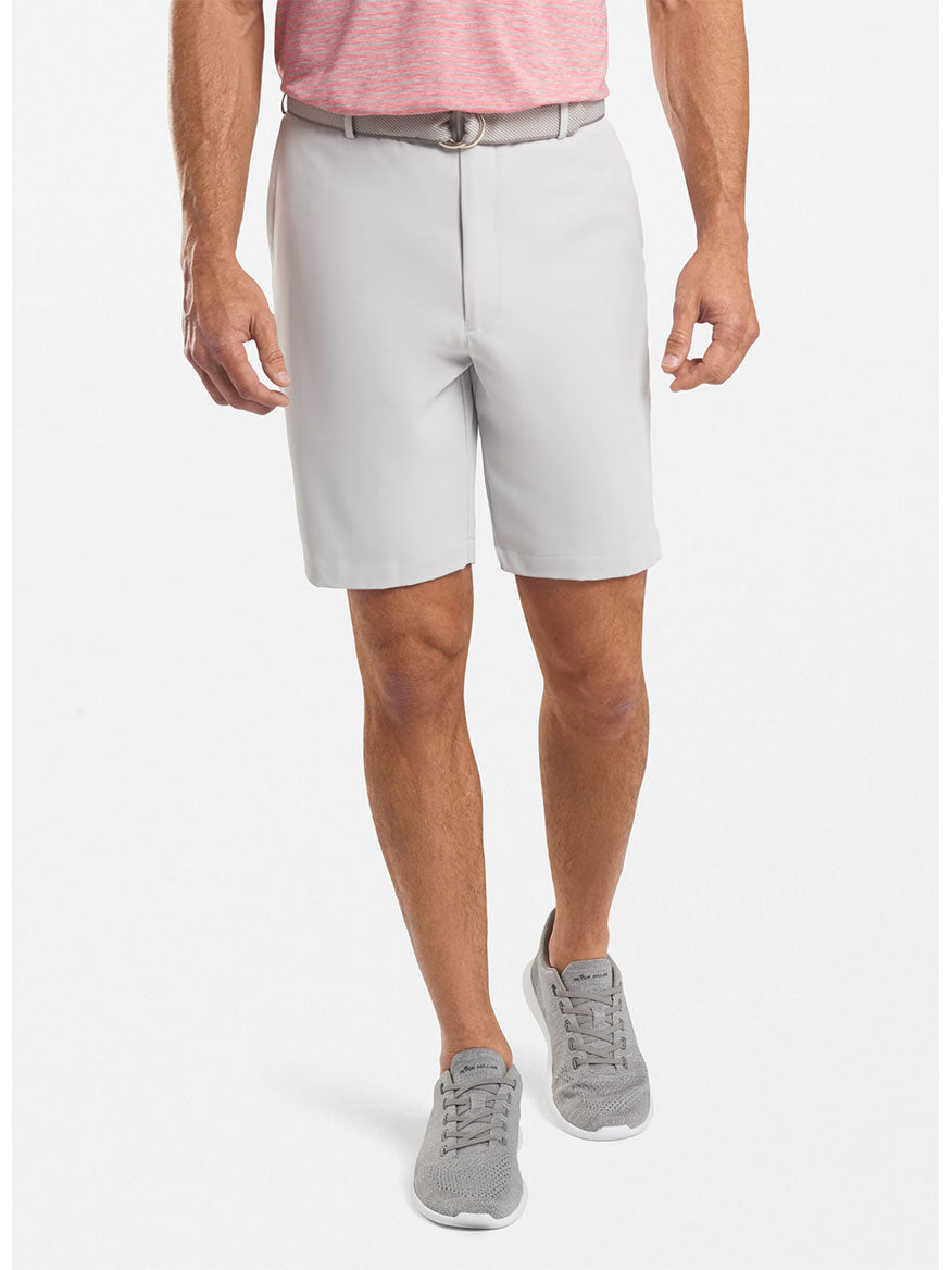 Frontal view of a man from the waist down, wearing Peter Millar Salem High Drape Performance Short in British Grey and sneakers.
