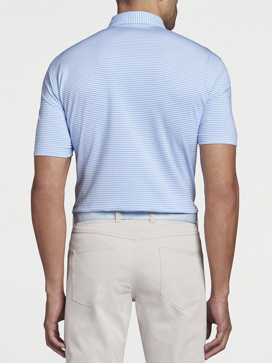 Man seen from behind wearing a Peter Millar Hales Performance Jersey Polo in Cottage Blue and khaki pants.