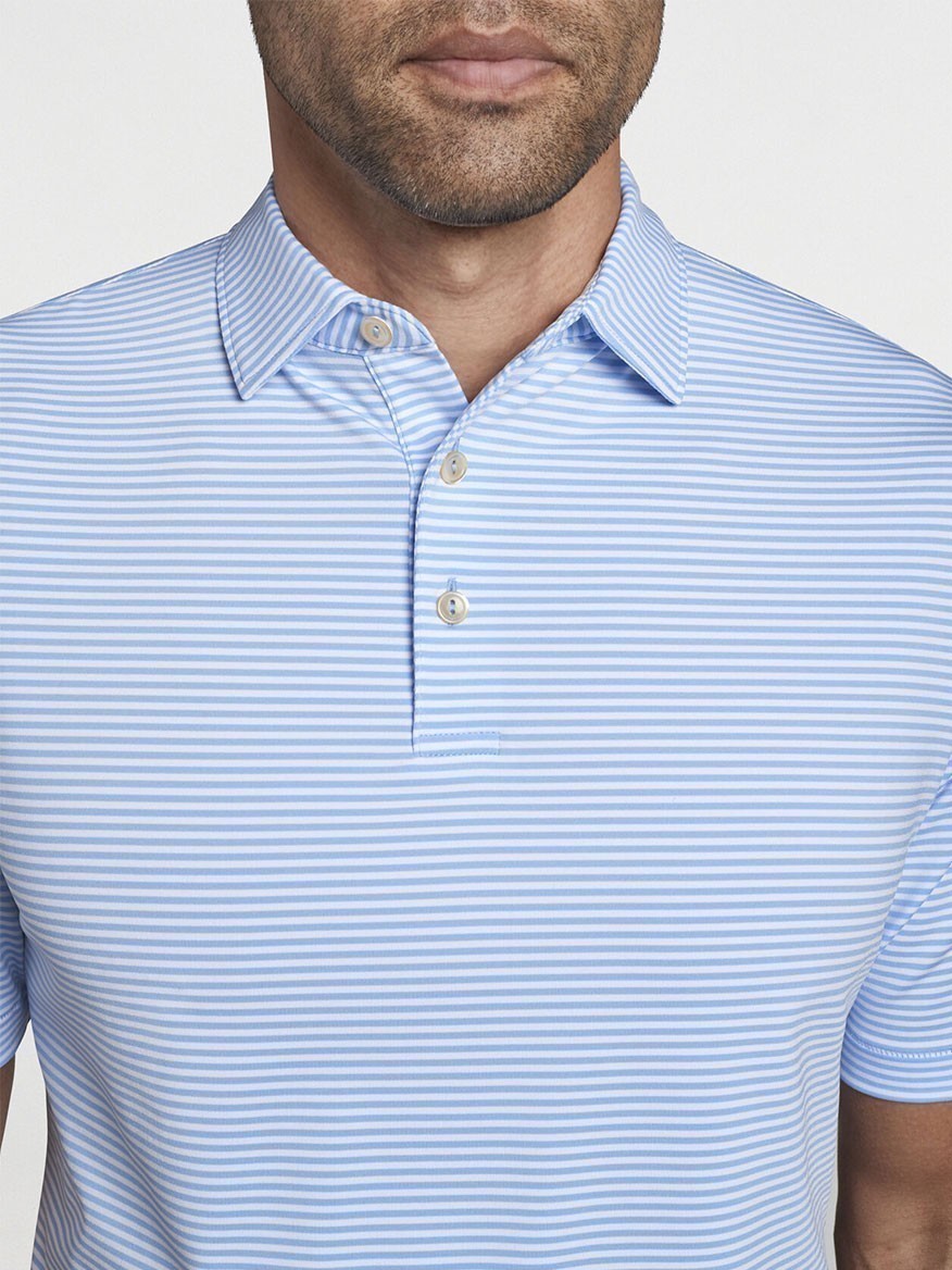 A man wearing a Peter Millar Hales Performance Jersey Polo in Cottage Blue.