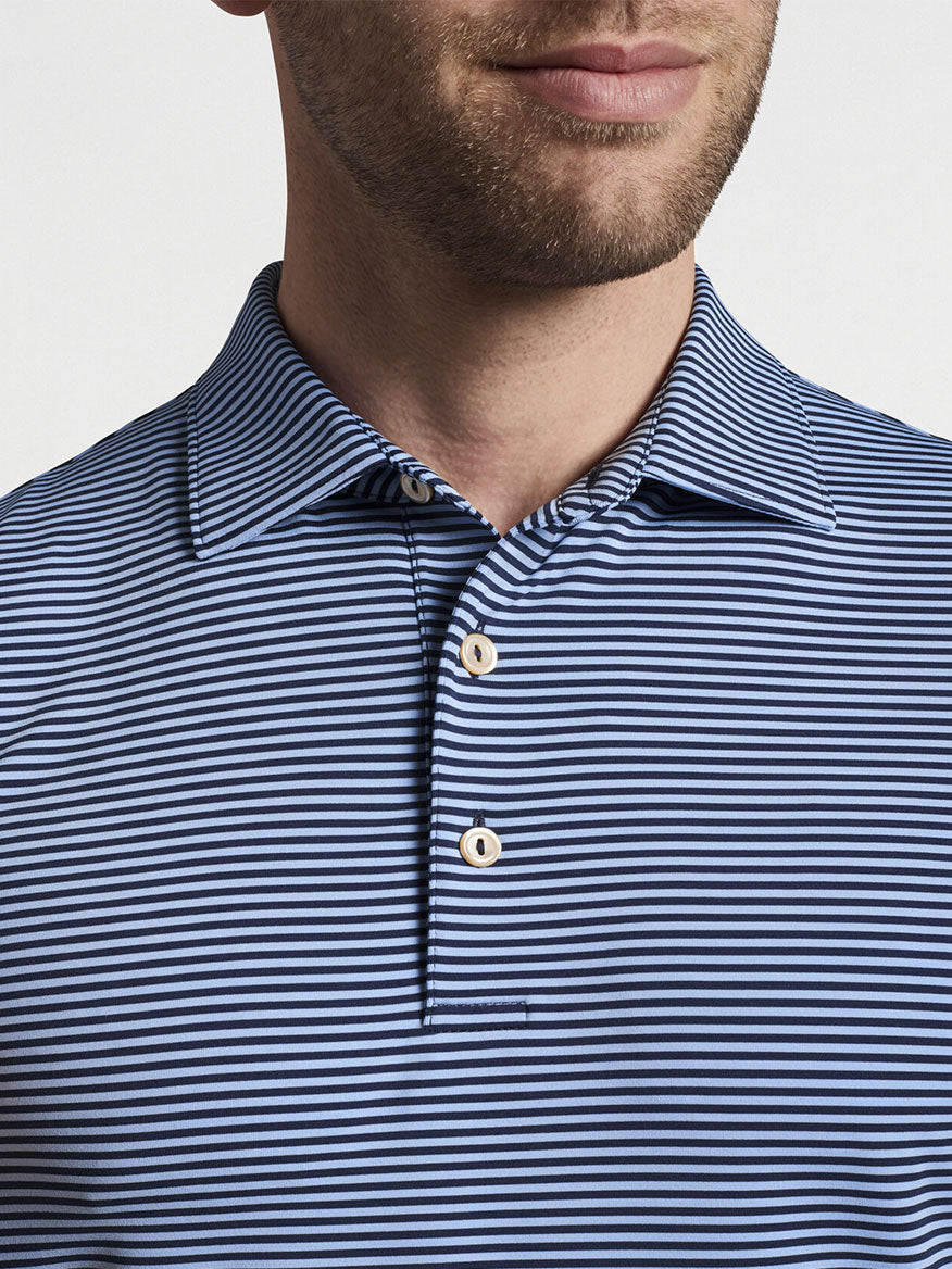 Man wearing a Peter Millar Hales Performance Jersey Polo in Navy/Cottage Blue with top buttons undone.