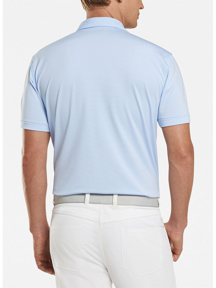 The back view of a man wearing a Peter Millar Jubilee Stripe Performance Polo in Cottage Blue.