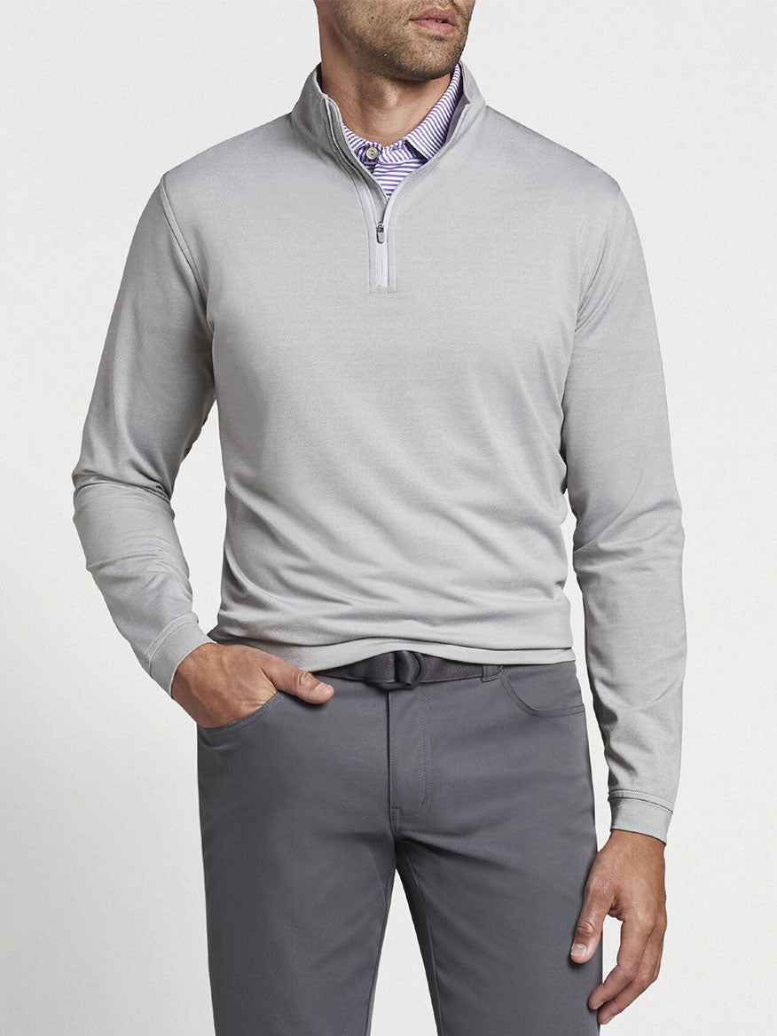 Man wearing a Peter Millar Perth Melange Performance Quarter-Zip in Gale Grey and grey trousers with a visible shirt collar underneath.