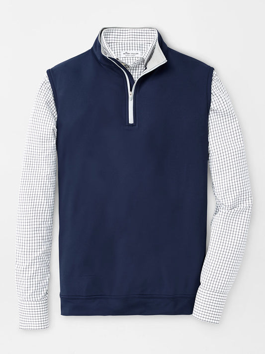 A men's Peter Millar Galway Performance Quarter-Zip Vest in Navy with a checkered shirt.