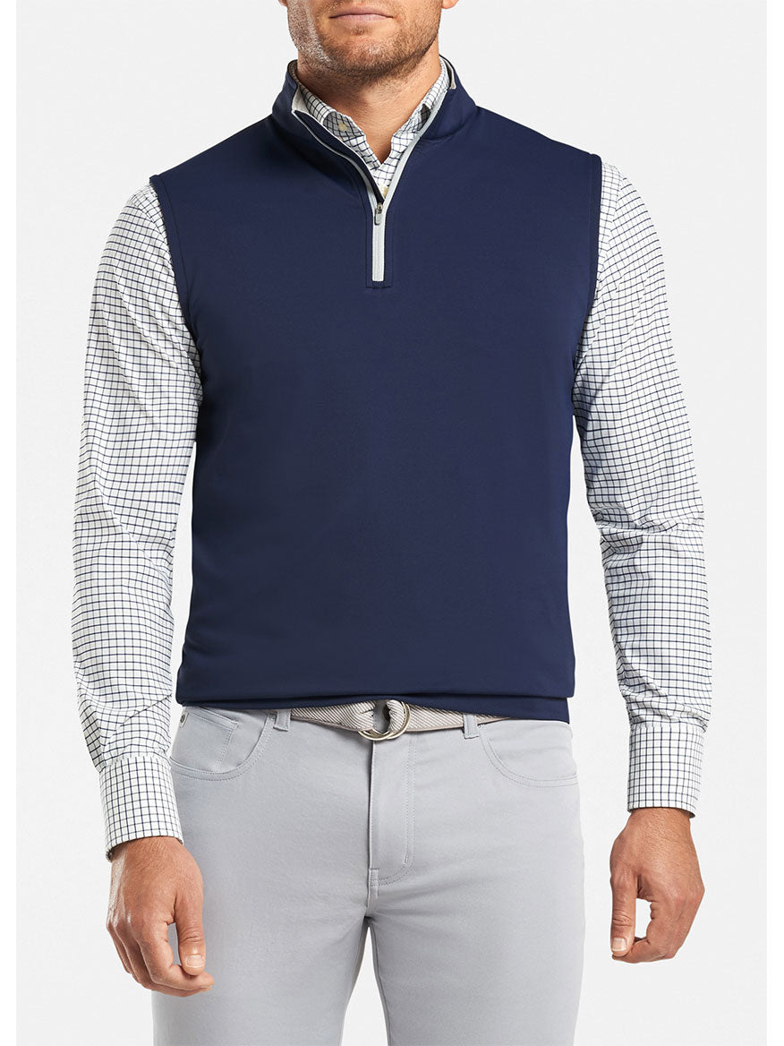 The Peter Millar Galway Performance Quarter-Zip Vest in Navy is a performance vest made with moisture-wicking fabric.