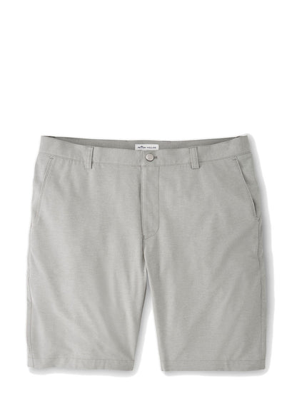 The Peter Millar Shackleford Performance Hybrid Short in British Grey is made with a versatile and performance fabric, offering four-way stretch. They are showcased on a white background.