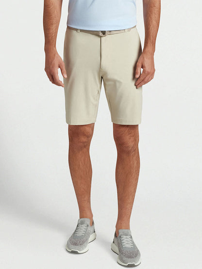 Peter Millar's Shackleford Performance Hybrid Short in Sand is perfect for sunny days on the golf course.