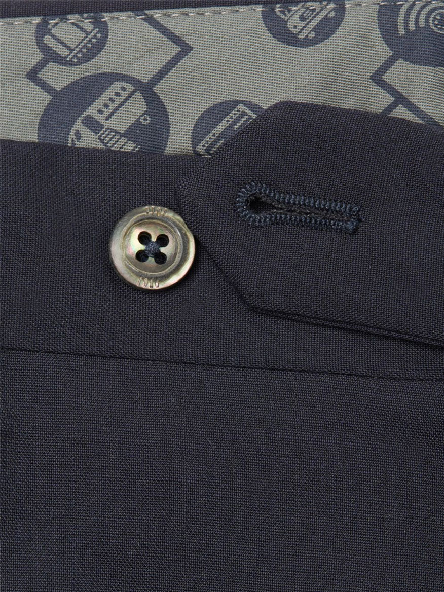 A close up of the slim fit button on a PT01 Travel Wool Performance Trousers in Black suit.
