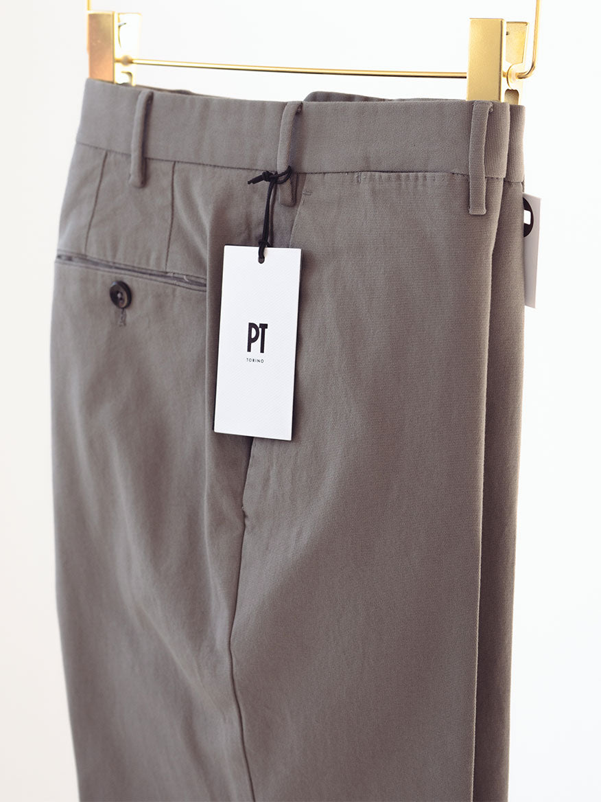 A pair of PT01 Dressy Stretch Canvas Trousers in Dark Grey hanging on a hanger.