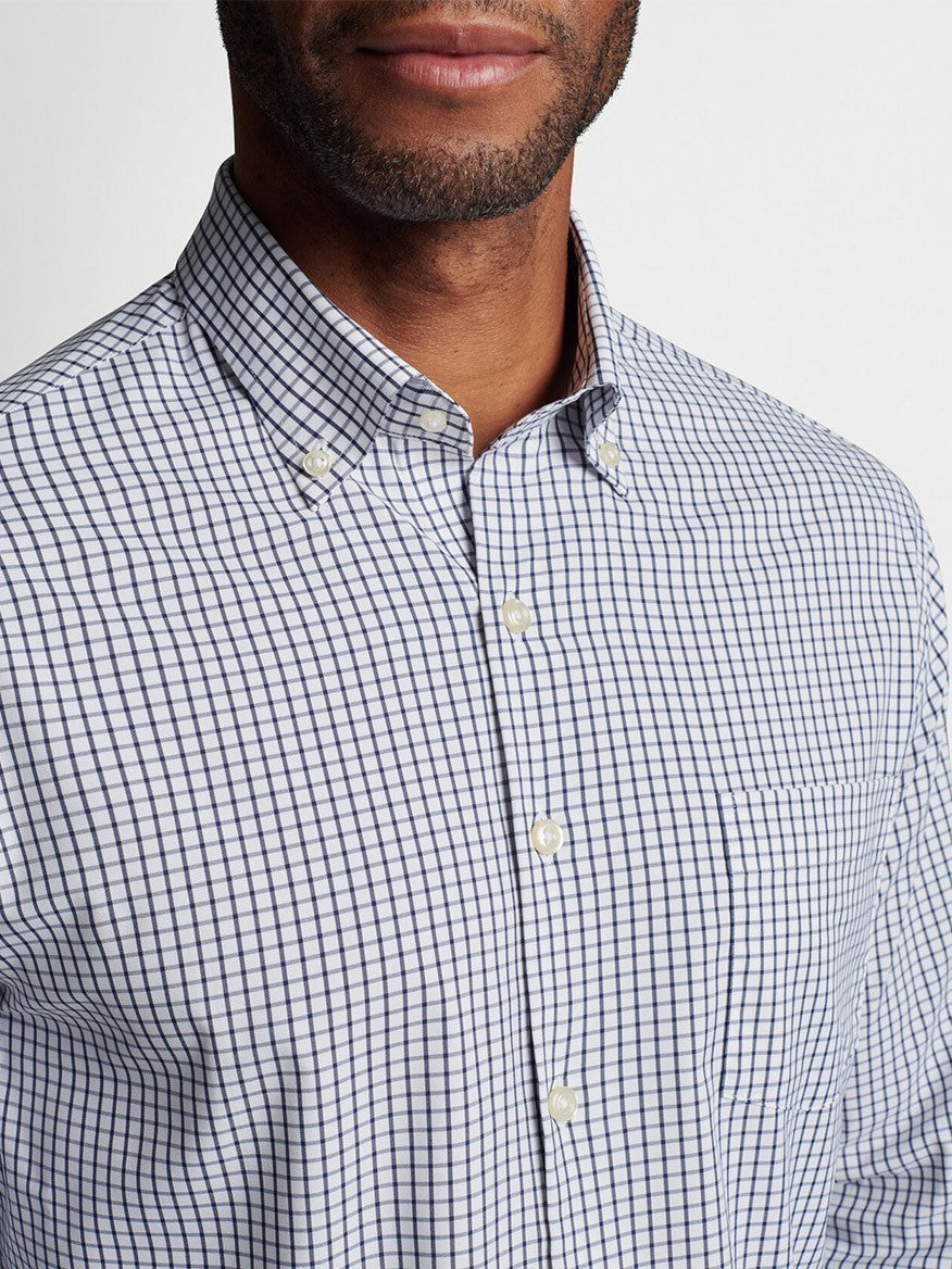 A close-up of a man wearing a Peter Millar Hanford Performance Twill Sport Shirt in Navy.