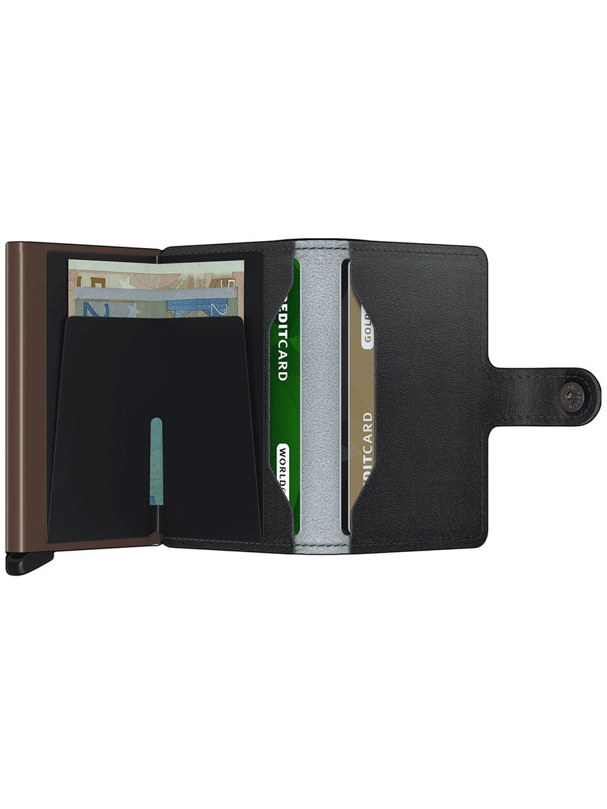 A black Secrid Miniwallet Art in Goldfinch with a Cardprotector clip, containing cash and multiple cards, opened to show contents.