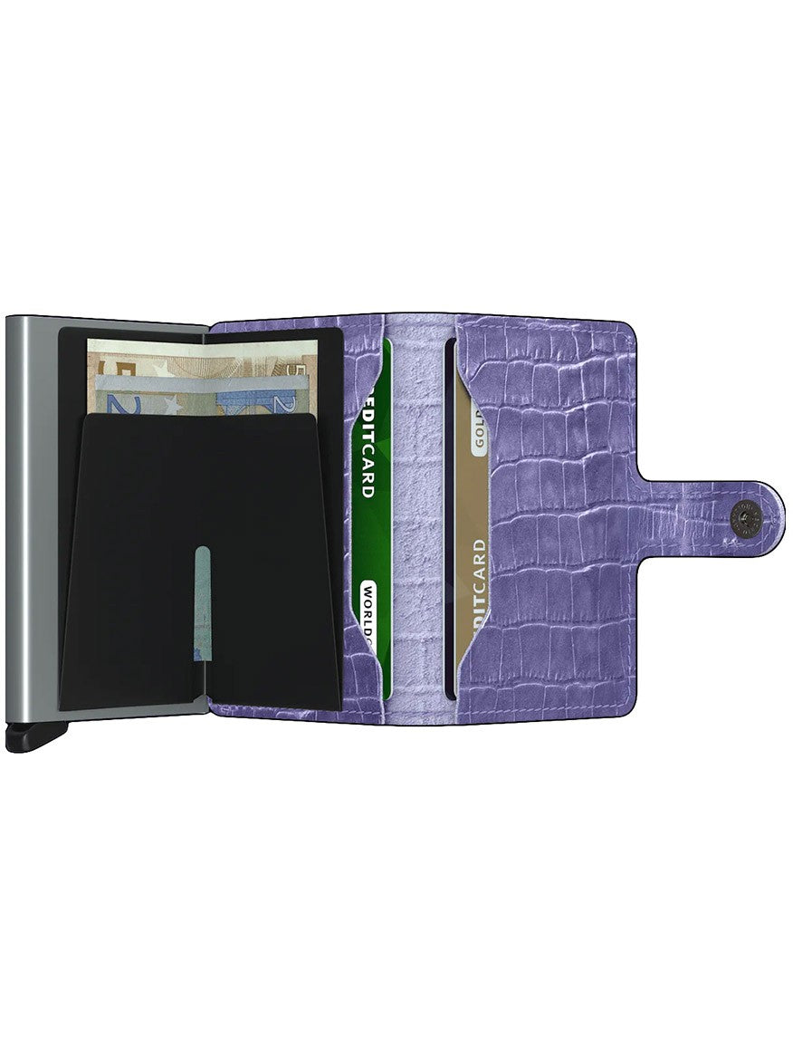 An open Secrid Miniwallet Cleo in Lavender with money, and multiple card slots displaying a metro card and a credit card, featuring wireless communication protection.