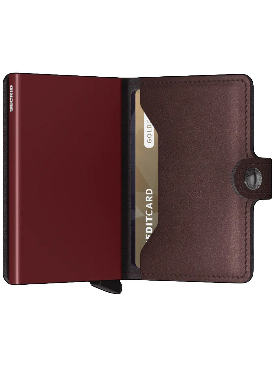 A Moro Secrid Miniwallet Metallic with RFID protection and a gold credit card inside.