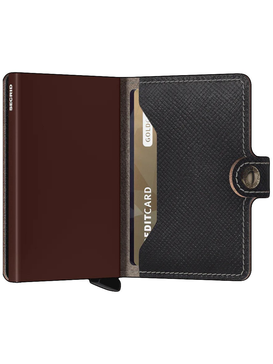 Brown Secrid Miniwallet Saffiano with RFID protection and a gold credit card inside.