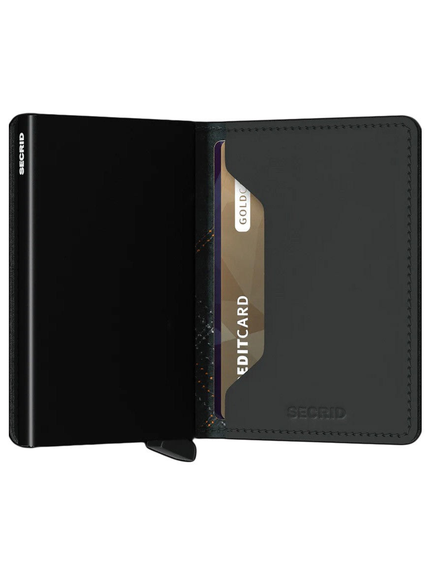 A black Secrid Slimwallet Stitch in Linea Orange with a gold-colored card partially slid out, offering RFID protection.