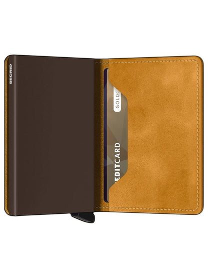 A Secrid Slimwallet Vintage in Ochre with a credit card in its aluminium cardprotector.