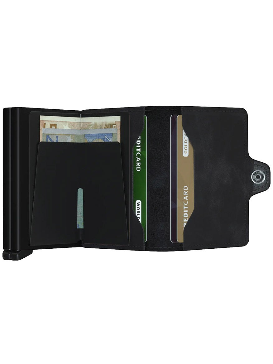 A black Secrid Twinwallet Vintage in Black opened to reveal cash and several cards.