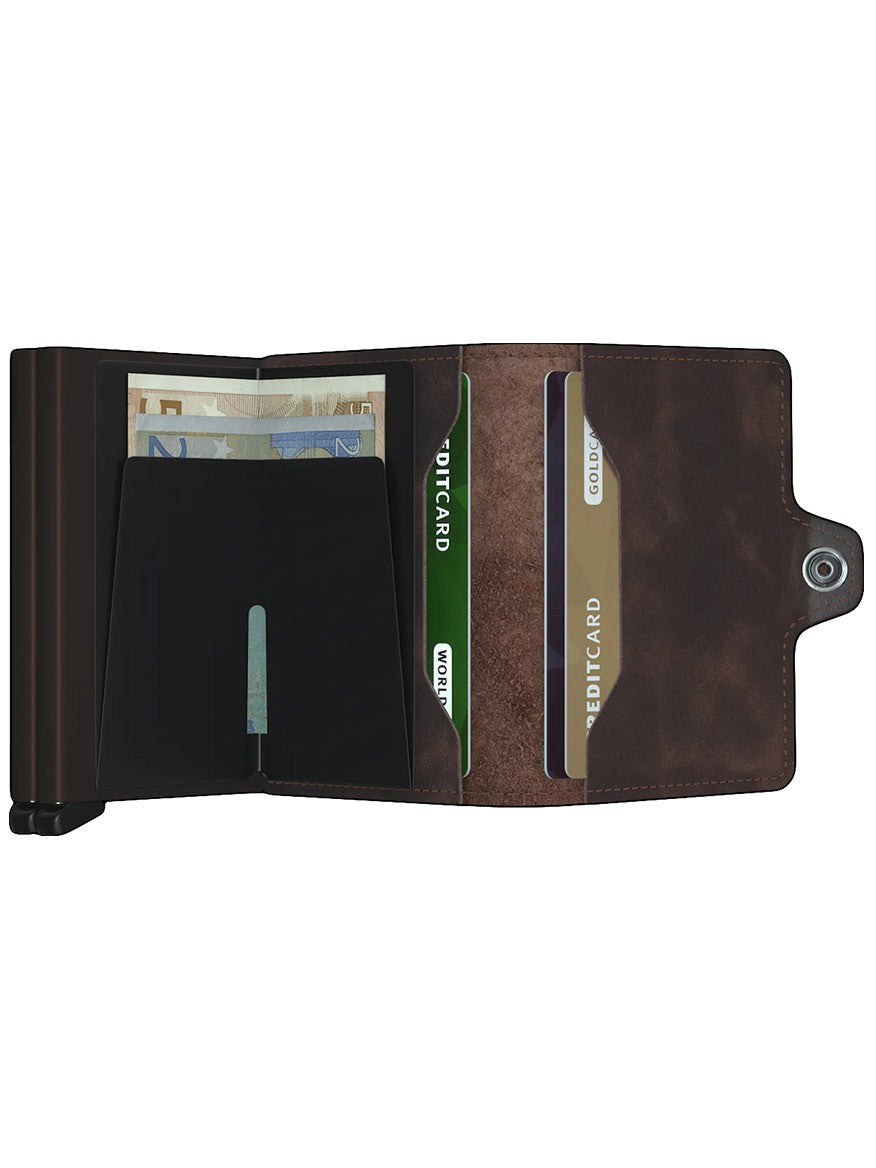 A compact brown Secrid Twinwallet Vintage in Chocolate with a credit card and banknotes in it.