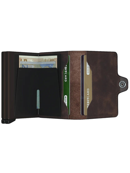 A compact brown Secrid Twinwallet Vintage in Chocolate with a credit card and banknotes in it.