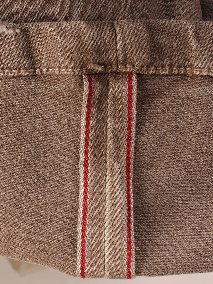 Close-up of a beige Teleria Zed Cobra selvedge stretch denim in Tortora with a red and white selvedge detail, made in Italy.