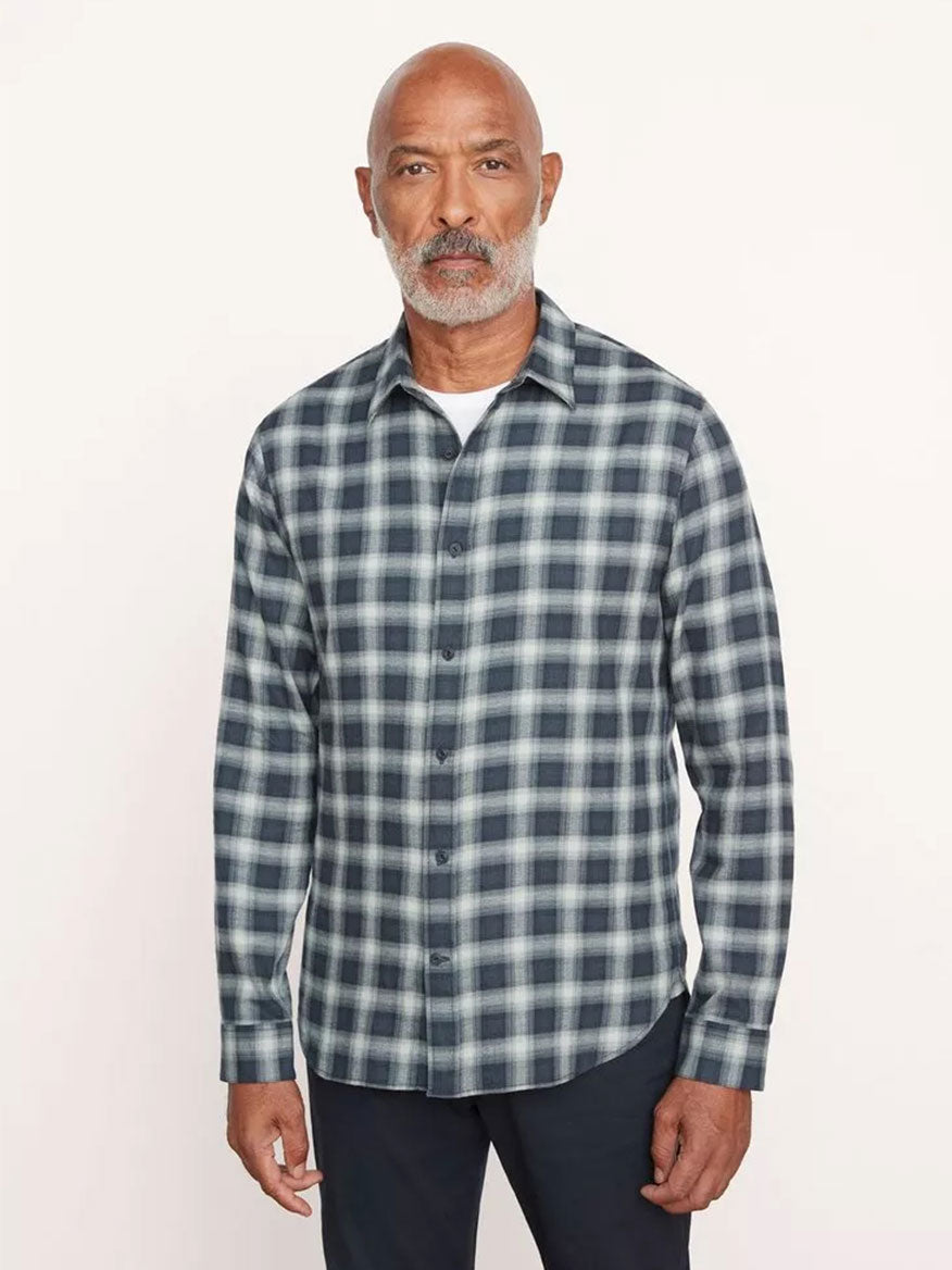 A man with a white beard wearing a Vince Glen Oak plaid long sleeve shirt in Deep Seaweed stands against a plain background.