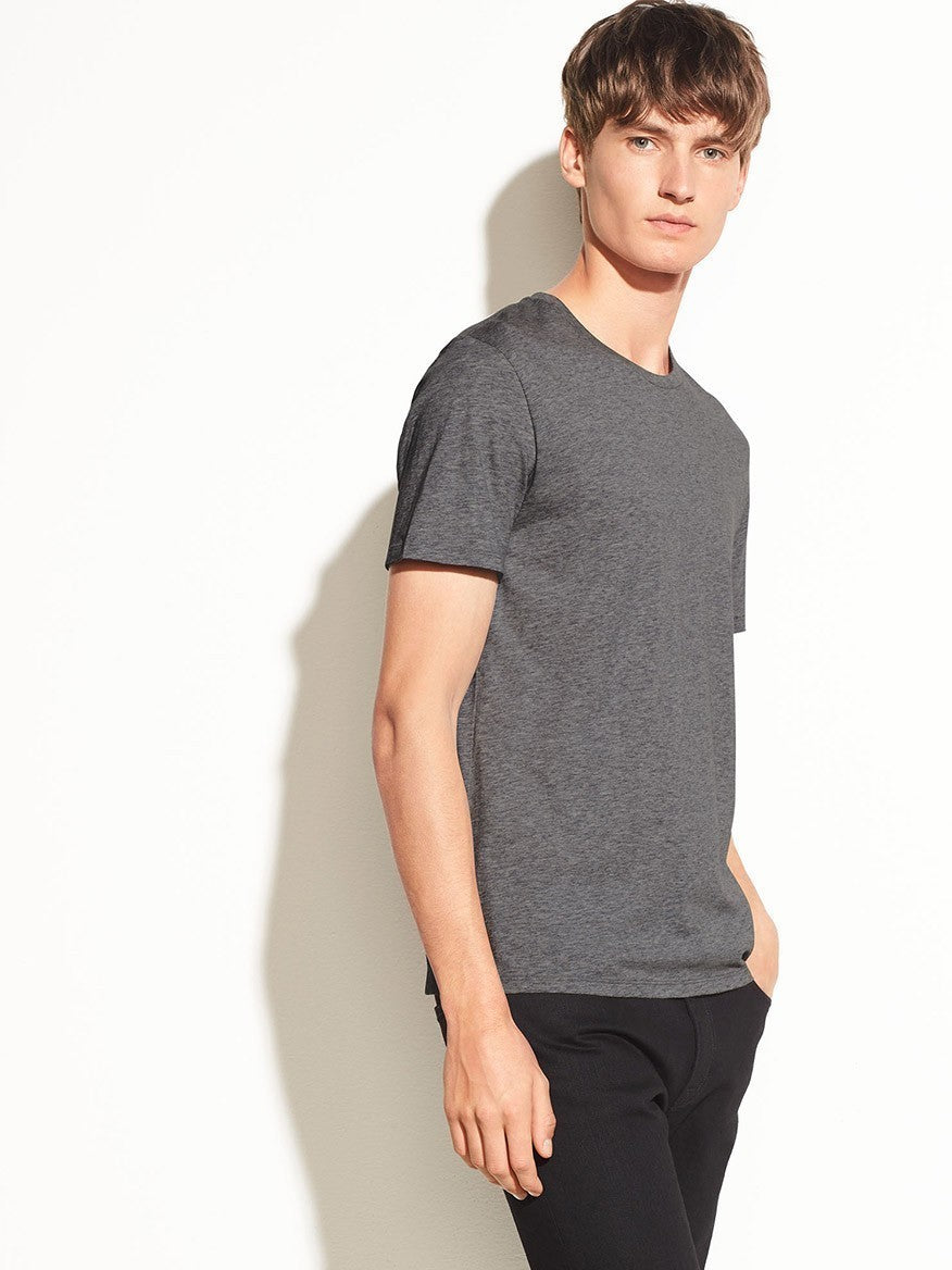 Man in a Vince Crew Neck T-Shirt in Heather Carbon posing against a white background.